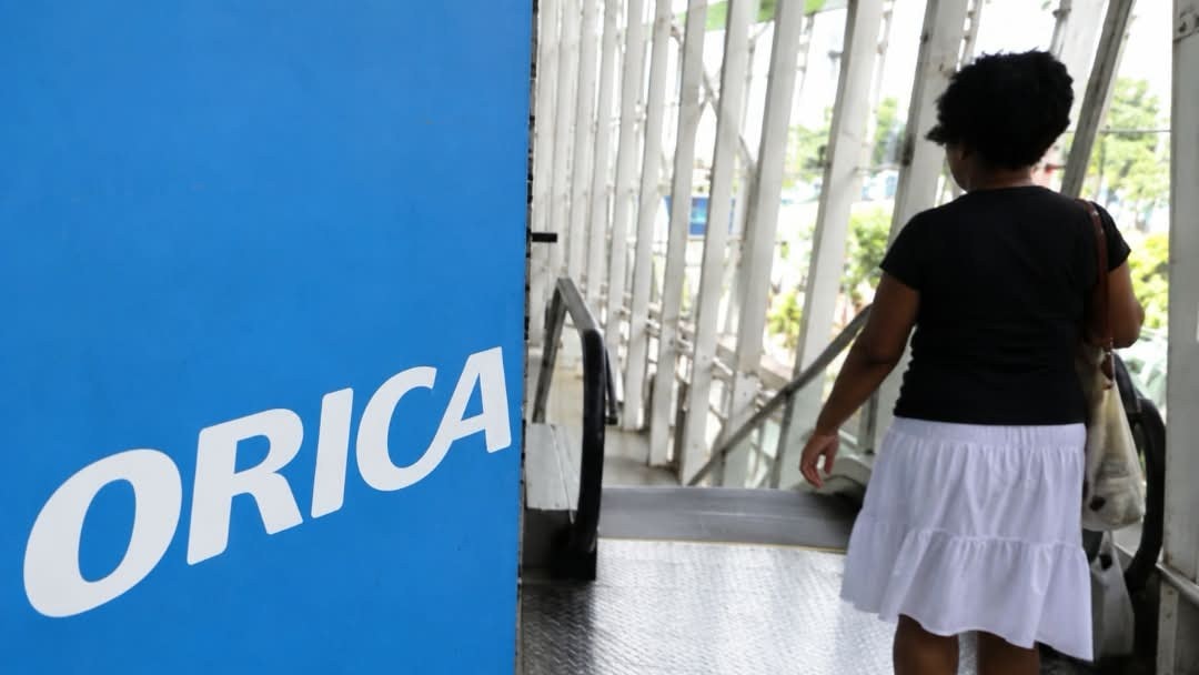 Orica signage beside a walkway as a woman walks towards the stairs