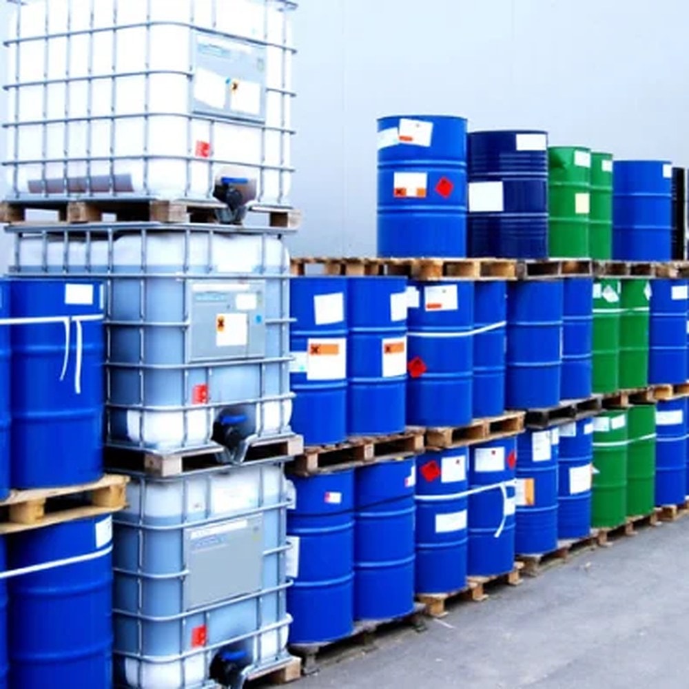 Palletised chemical drums and IBC containers stacked in storage
